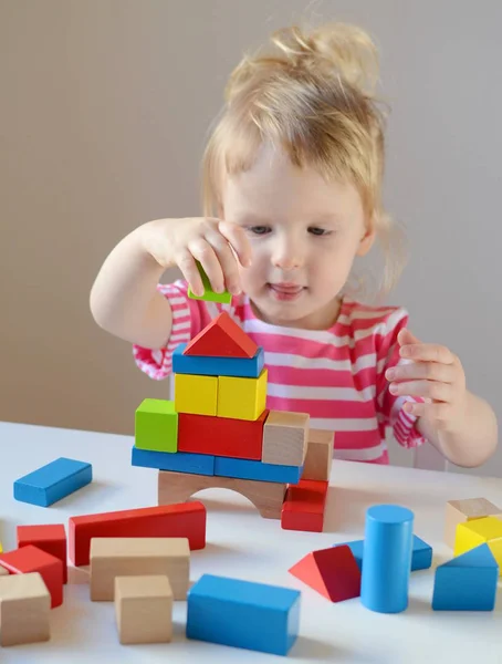 Little  girl playing with wooden cubes — Stock Photo, Image