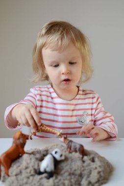 Küçük kız, eve erken eğitim Kinetik kumla oynayan 