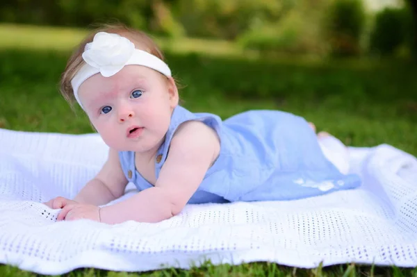 Petite fille bébé couché dans l'herbe verte — Photo