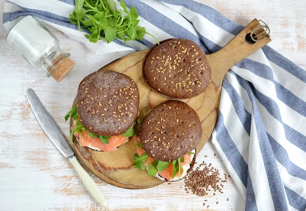 Somon Sandviç krem taze ve roka kesme tahtası üzerinde füme