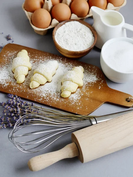Baking Ingredients for Cooking Croissants. Dough, Eggs, White Sugar, Flour, Milk, Oil Butter. Preparation, Lavender Flowers. Kitchen Cuisine Table Grey Background, Homemade