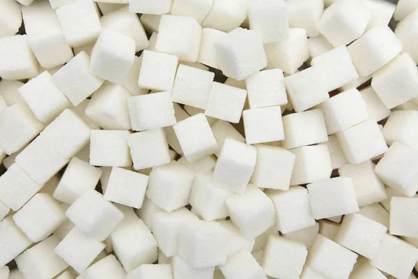 Background of pieces of white refined sugar from beet. — Stock Photo, Image