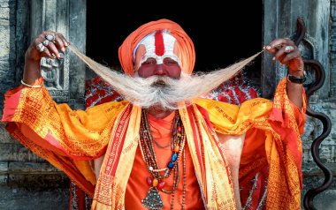 KATHMANDU,NEPAL/OCTOBER 29,2006: Hindu demonstrates mustache Pas clipart