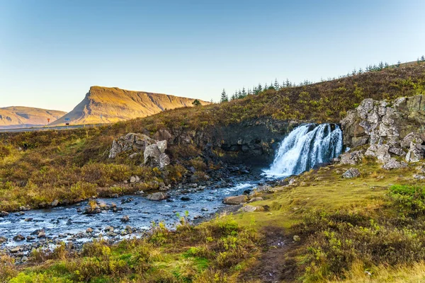 Small waterfall and a mountain stream — Stock Photo, Image