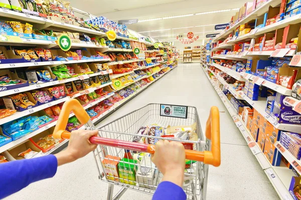 ロンドン 2014年7月3日 買い物客がセインズベリーのスーパーマーケットの通路に沿ってトロリーを押しています セインズベリーは英国で2番目に大きなスーパーマーケットで 2013年に230億の収益を上げています — ストック写真