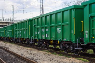 Burgas, Bulgaria - March 20, 2017 - Freight cargo train - 4axled box wagon green Type:Eanos Model:155-1 - Transvagon AD clipart