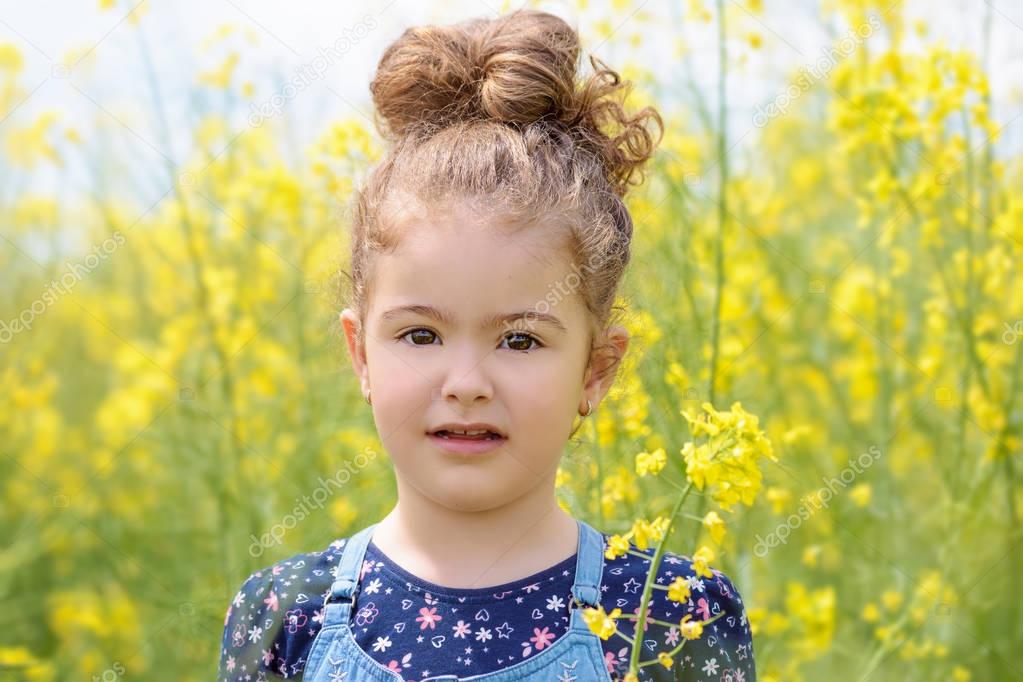 Lovely sweet girl happy beautiful woman on blooming rapeseed field in spring