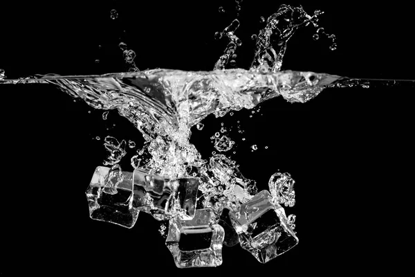 Ice splash in water on black background — Stock Photo, Image