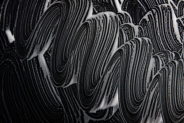 Beyaz sabun doku güzel beyaz köpük üzerinde siyah arka plan el yapımı hipster köpük doku soyut