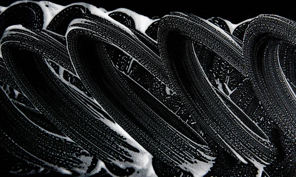 Beyaz sabun doku harika beyaz köpük üzerinde siyah arka plan el yapımı hipster köpük doku soyut