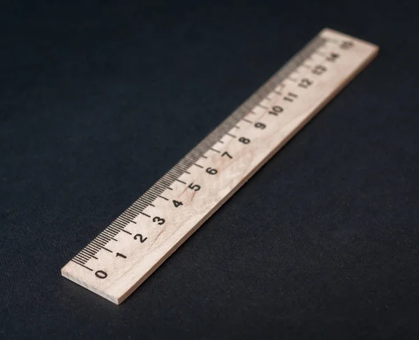 Wooden ruler on a black background. Ruler Simple. School board background. — Stock Photo, Image
