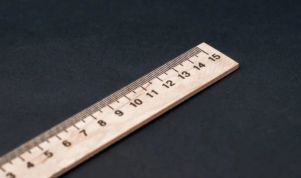 Fifteen cm. Regular size. Wooden ruler on a black background. Ruler Simple. School board background. 1 5 — Stock Photo, Image