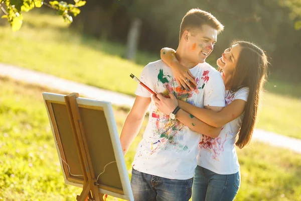 Young girl embracing her boyfriend at his chest from behind with — Stock Photo, Image