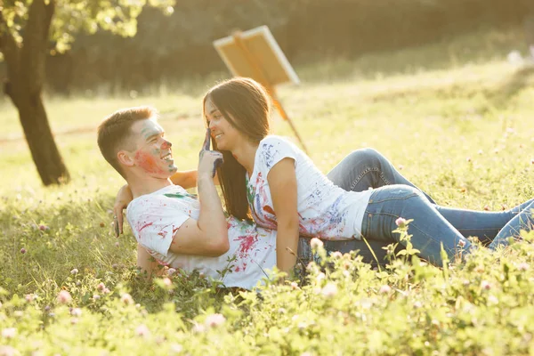 Young beautiful woman laying on her boyfriend wearing colorized — Stock Photo, Image