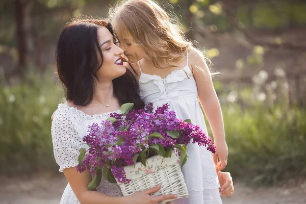 Young beautiful mother and little daughter having fun together. — Stock Photo, Image