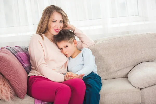 Mother trying to calming down son at home