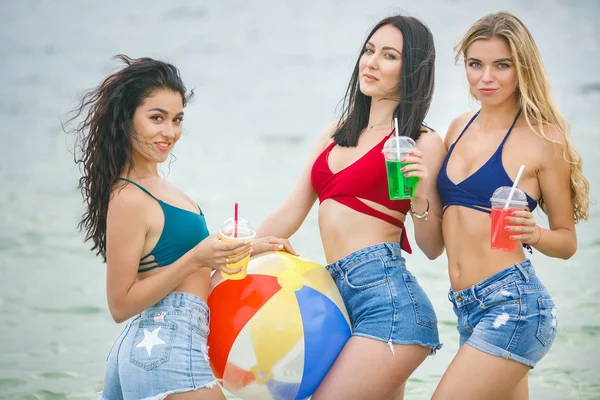 Young attractive women at the beach party having fun. Pretty girls having fun