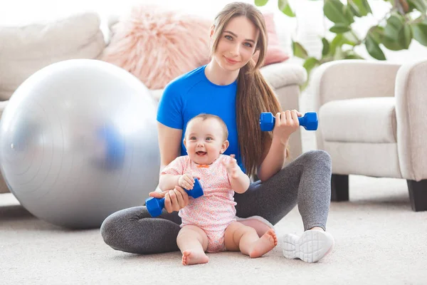 Young Pretty Mother Working Out Her Little Child Home — Stock Photo, Image