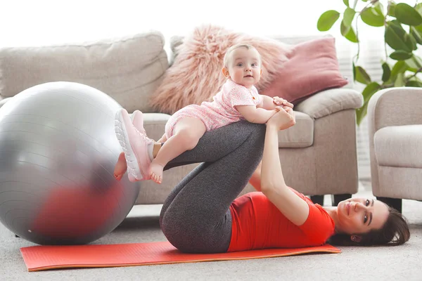Young Pretty Mother Working Out Her Little Child Home — Stock Photo, Image