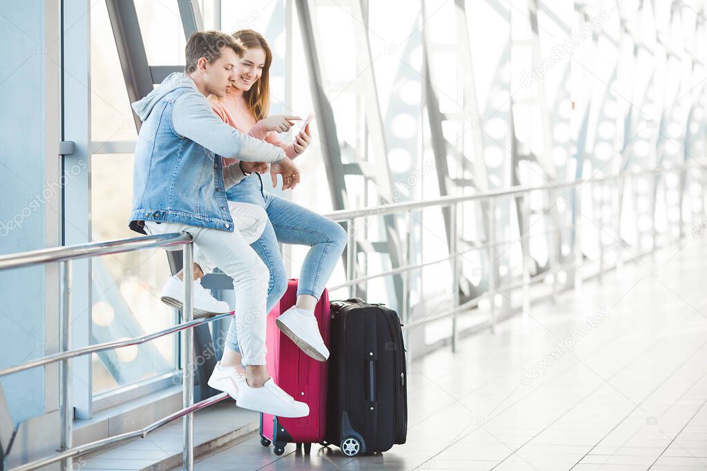 Couple traveling. Lovers journey. Young man and woman in the airport. Family tour.