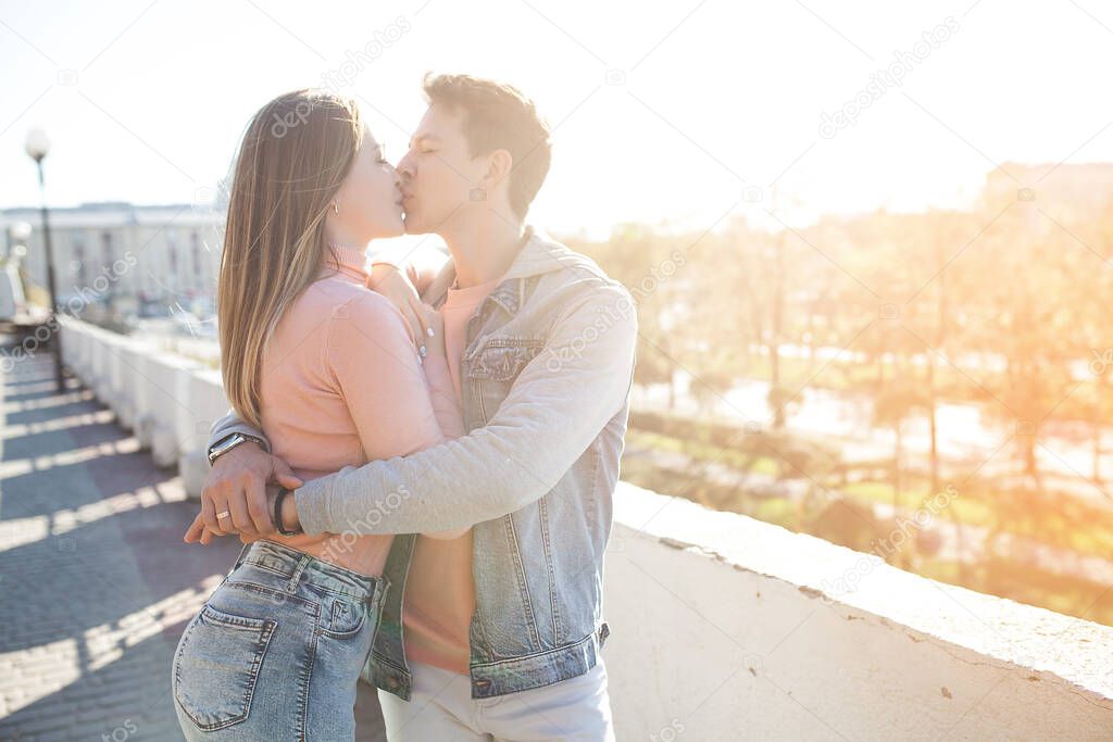 Lovely couple having fun. Young attractive woman and handsome man together walking in the city. Relationship.