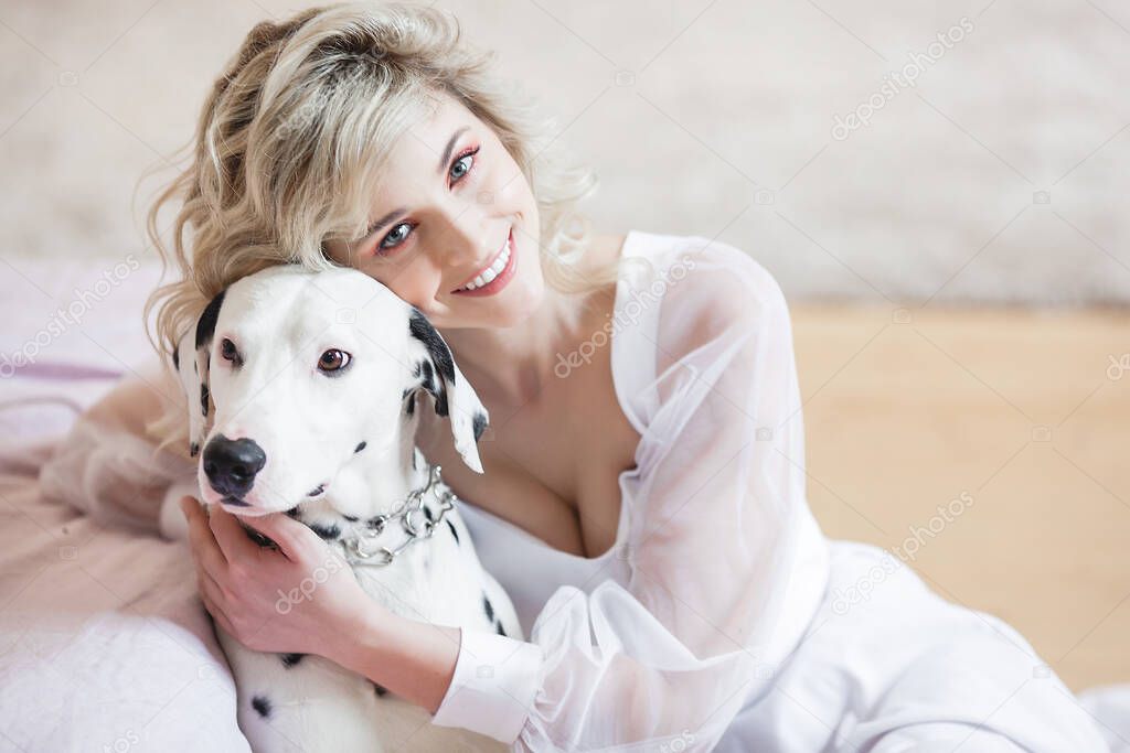 Pretty young female with dog dalmatian. Best friends. Love pet and human.