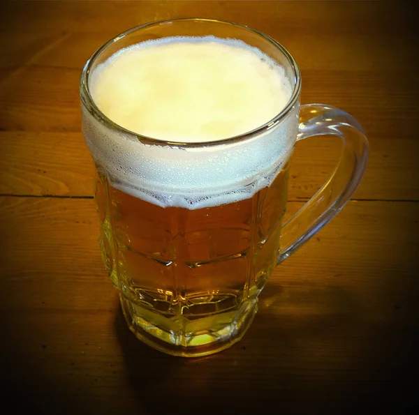 A mug of beer on the table — Stock Photo, Image