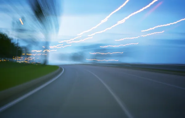 Evening road with blurred lights — Stock Photo, Image