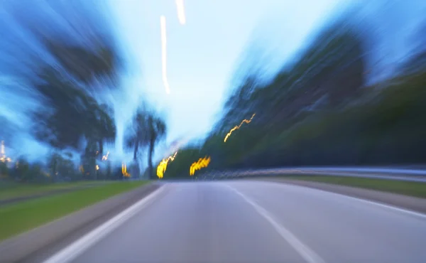 Evening road with blurred lights — Stock Photo, Image