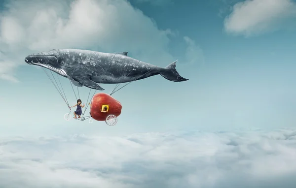 Whale with apple and two girls over clouds — Stok fotoğraf