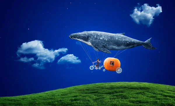 Whale with pumpkin and two girls over grass — Stock Photo, Image