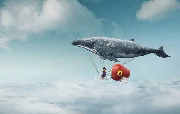 Whale with apple and two girls over clouds — Stok fotoğraf