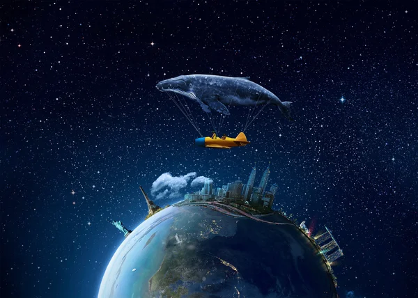 Whale with aircraft and two girls over globe — Stockfoto