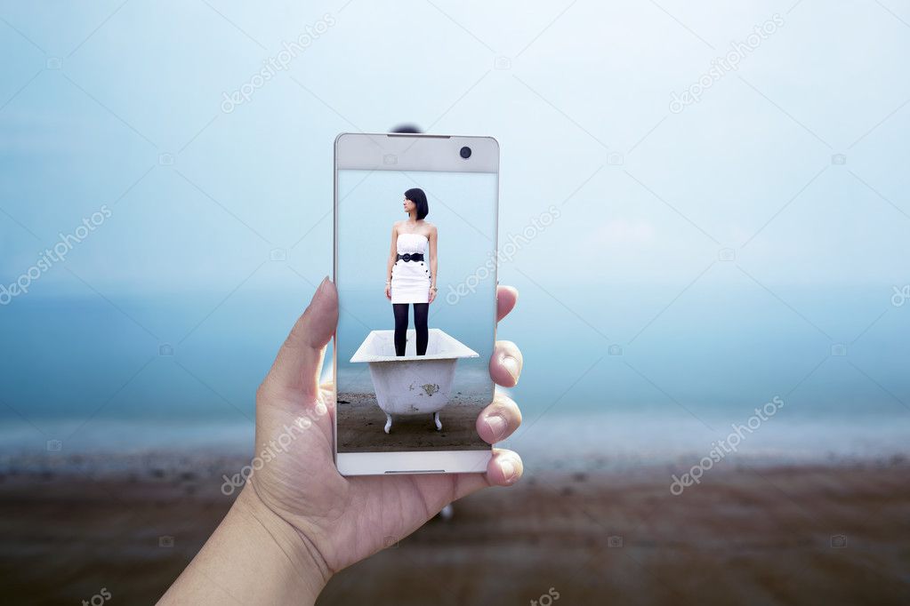 smartphone with picture of woman standing in bathtub