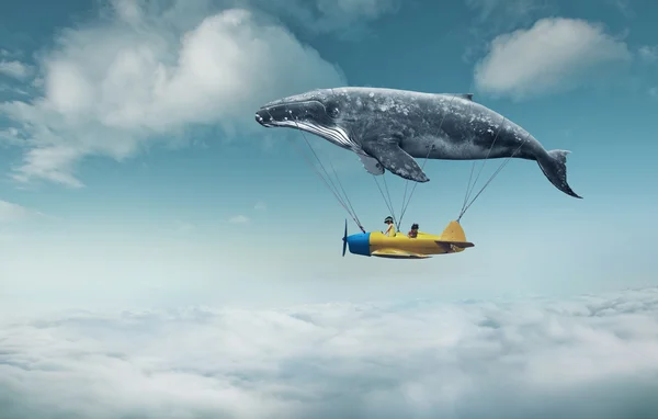 Whale with aircraft and two girls over clouds — Stock Fotó