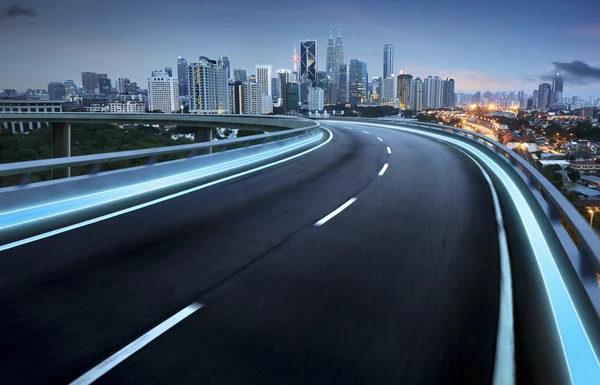 Highway overpass against city — Stock Photo, Image