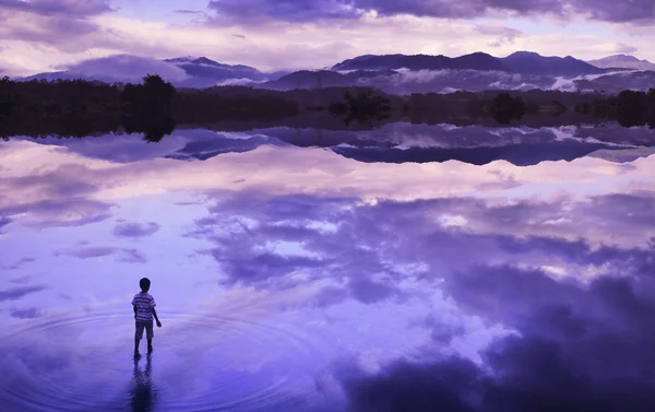 Boy walking in lake water
