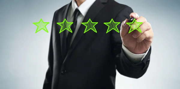 Businessman draws stars rating — Stock Photo, Image
