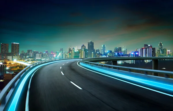 Neon light highway over cityscape