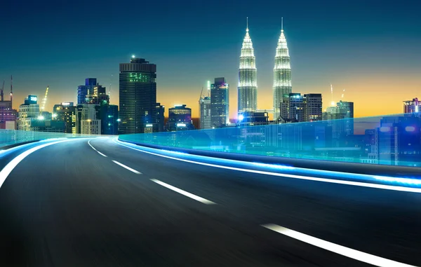 Neon light highway over cityscape — Stock Photo, Image