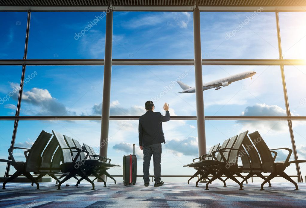  businessman waving at airport