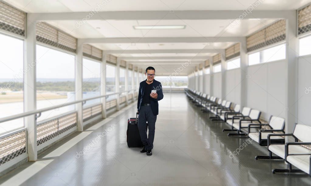 Man using smartphone in airport