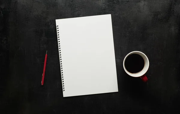 Notebook and coffee on working table — Stock Photo, Image