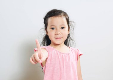 Asyalı güzel kız bir parmağını gösterir