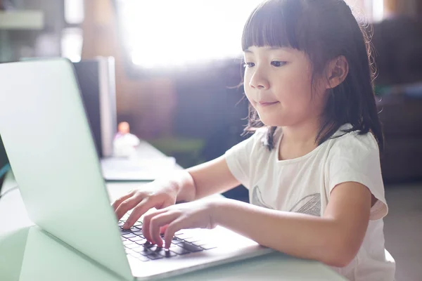 Little asian girl using laptop — Stock Photo, Image