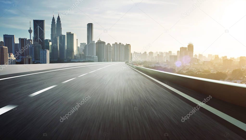 Highway overpass with city skyline