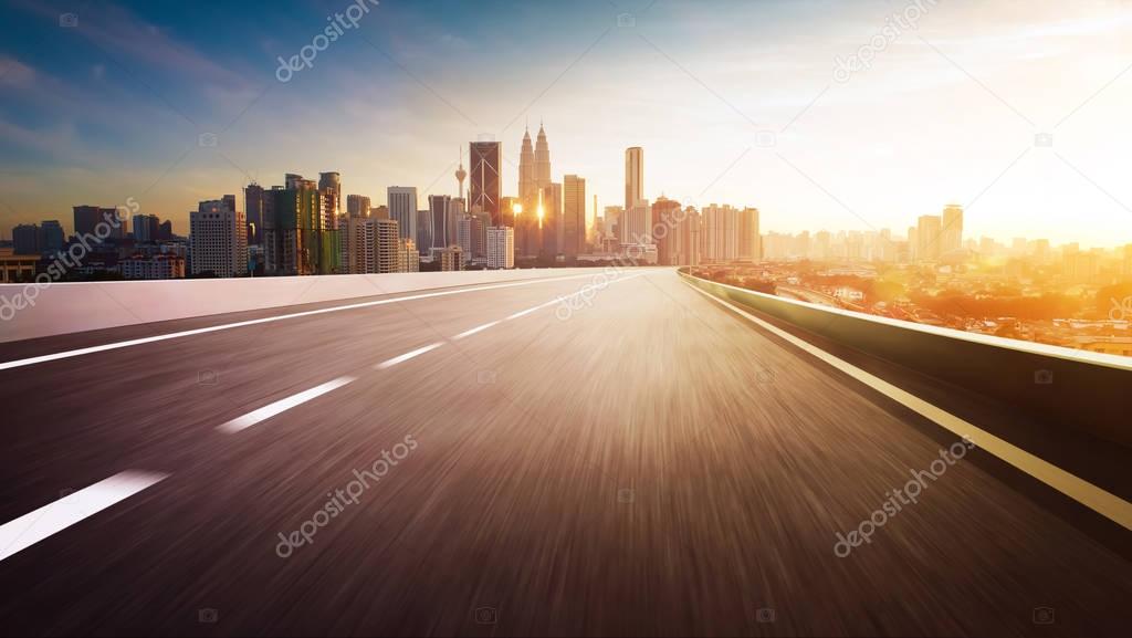 Highway overpass with city skyline