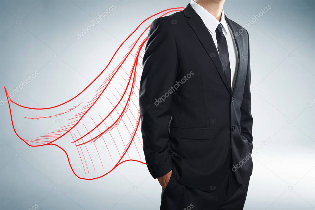 Businessman with drawn cape