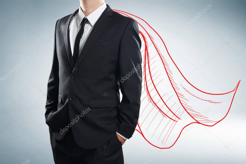 Businessman with drawn cape