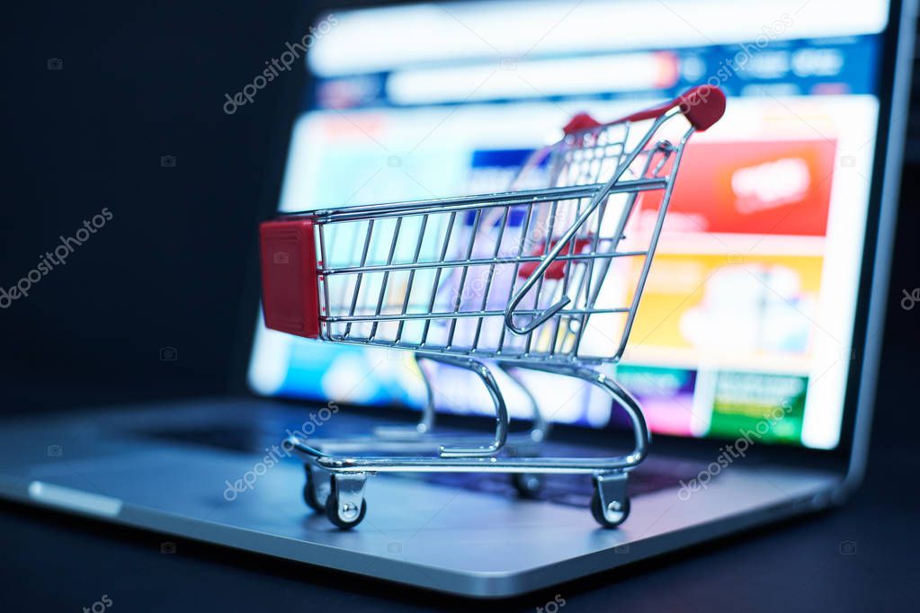 Shopping cart and laptop
